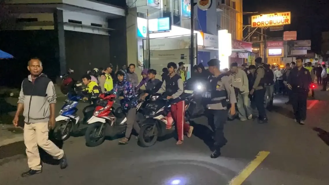 Puluhan pelajar mendorong sepeda motor menuju Mapolsek Majenang usai terjaring razia balap liar. (Faiz Ardani)