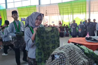 Siswa SMP Sultan Agung Kawunganten Cilacap yang lulus menyerahkan seragam layak pakai kepada kepala sekolah. (Faiz Ardani).